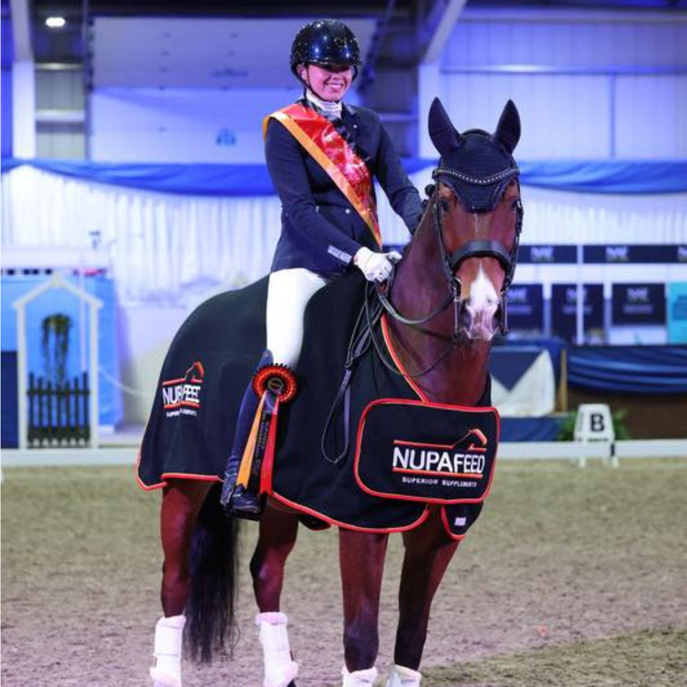 Carmen Gammie on her dressage horse winning the silver freestyle dressage championship